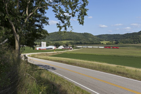 Canadian Pacific local freight train B27 climbing Stockton Hill near Stockton, Minnesota, on August 31, 2013. Two brand-new SD30C-ECO locomotives lead 58 cars into the 1.7 percent grade out of the Mississippi River Valley.
