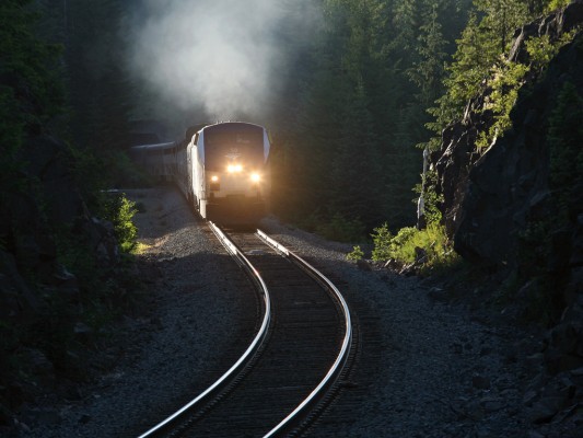 Amtrak's southbound Coast Starlight cruising up the Cascades near Cruzatte, Oregon. The rockshed protecting the south portal of tunnel 5 is visible at rear.