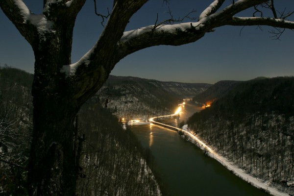 Running several hours late, Amtrak's westbound "Cardinal," train no. 51, streaks across the New River at Hawks Nest, West Virginia, on a moonlit winter night in 2005.