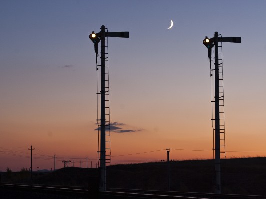 Crescent moon setting behind a pair of Jitong Railway semaphores at Gulumanhan.