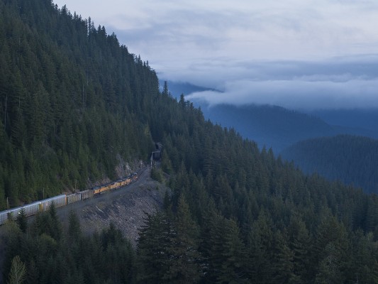 Fog swirls over the Salt Creek Valley in the Oregon Cascades before sunrise on May 23, 2009, as Union Pacific's Roseville to Portland freight train heads north.