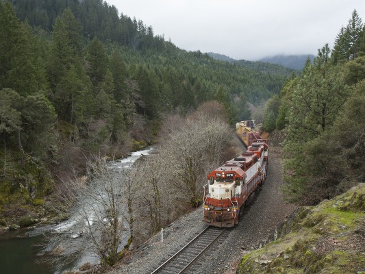 Central Oregon and Pacific Railroad freight train rolling up Cow Creek near Glendale, Oregon, where it will swap cars with another train out of Medford.