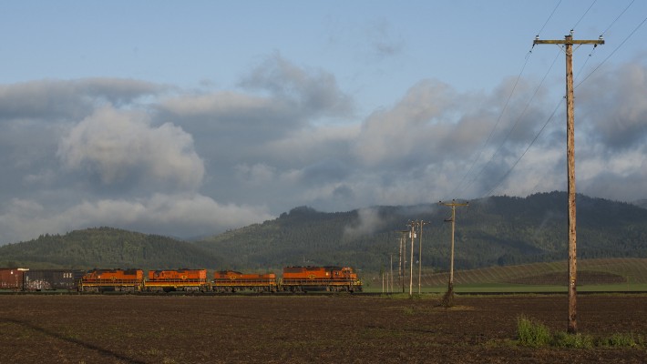 Portland and Western's Toledo Hauler rolls under power lines in the Willamette Valley between Corvallis and Albany, Oregon, just after sunrise on May 7, 2009.