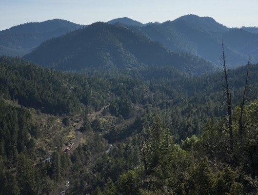 Southwestern Oregon's Siskiyou Mountains loom large as a Central Oregon and Pacific Railroad freight train rolls south on February 18, 2010.