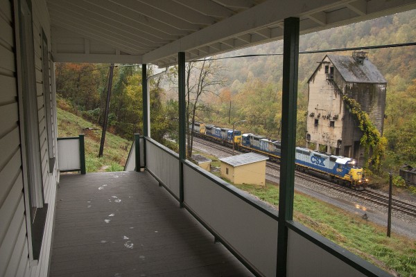 CSX westbound empty grain train passing the former Chesapeake & Ohio coaling tower in Thurmond, West Virginia, as seen from the steps of the town's boarding house.