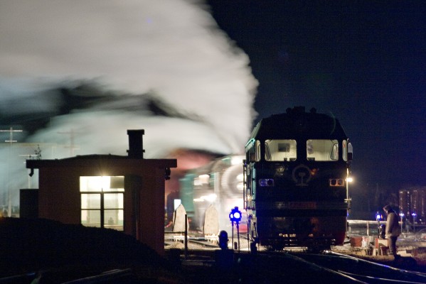 Steam replaces diesel on the Jitong Railway's morning passenger train at Daban, Inner Mongolia, China, in the wee hours of a fall day in 2005.