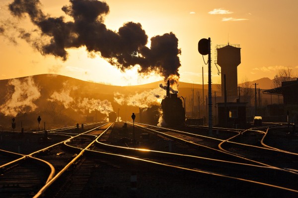 As the sun sets in Lindong, Inner Mongolia, China, an eastbound freight train pulls into the siding.