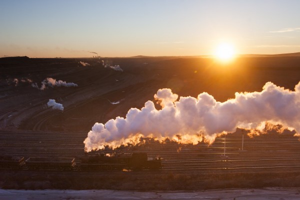 An SY locomotive pushes a train along the pit at Zhalainuoer as the sun sets in November 2005.