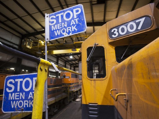 Blue flag protection indicates men working on Portland and Western 3007 inside the railroad's Albany shops on March 10, 2009. Shot on assignment for <i>Locomotive</i> magazine.
