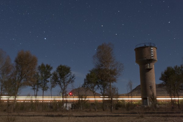 The Jitong Railway's diesel-powered, streamlined passenger train streaks through Gulumanhan, Inner Mongolia, China, on an October night in 2005.