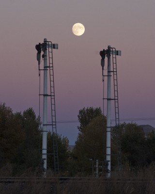 The full moon rises over the semaphore signals guarding the Jitong Railway at Gulumanhan, Inner Mongolia, China, in October 2005.