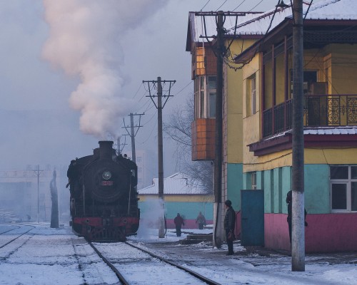 SY locomotive and colorful building on the Jixi Coal Railway in Heilongjiang, China.