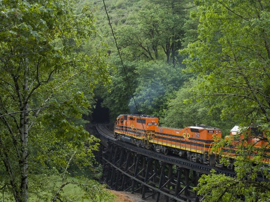 Portland and Western's Toledo Hauler crosses the Yaquina River and heads into a tunnel in the Coast Range mountains on June 10, 2010.