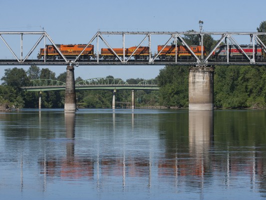 Portland and Western's Toledo Hauler crosses the Willamette River in Albany, Oregon, on the morning of July 11, 2008. The two green bridges in the background carry the east- and westbound lanes of U.S. 20.