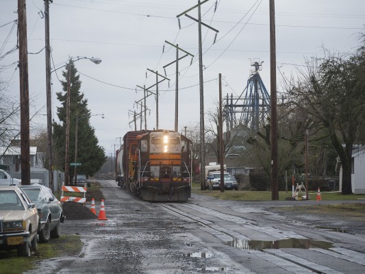 Portland and Western GP9 locomotive 1801 leads the American Turn north on Fourth Street in Harrisburg, Oregon, on December 21, 2009.