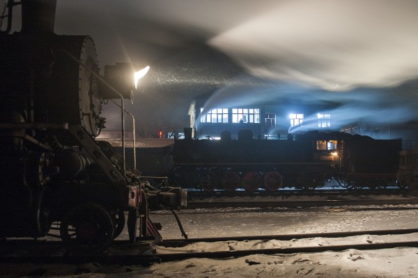 SY-class 2-8-2 steam locomotives at night in the Chengzihe Dongchang rail yard on the Jixi Coal Railway.