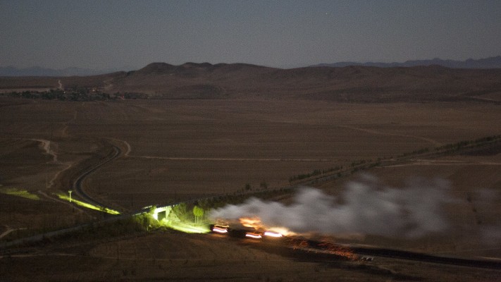 Westbound Jitong Railway freight train climbing the grade out of Tianshan (Chabuga), Inner Mongolia, China, under the light of the full moon in the wee hours of October 21, 2005.