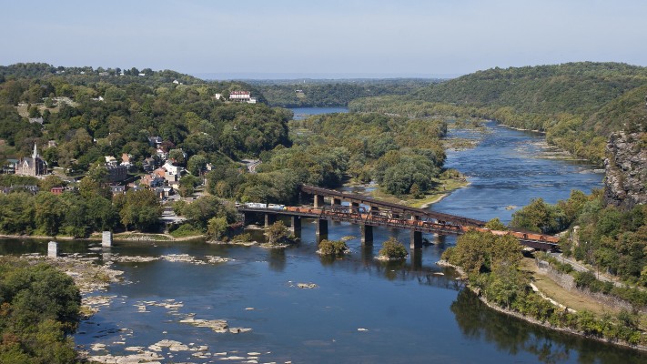 CSX's westbound "Rock Runner" crossing the Potomac River at Harpers Ferry, West Virginia, on a bright October day.