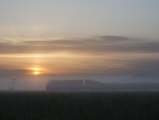Amtrak <i>Cascades</i> passenger train no. 500 rolls north as the sun rises through morning fog in western Oregon's Willamette Valley on May 15, 2009.