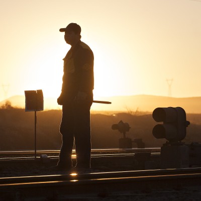 Jitong Railway worker at Tianshan (Chabuga), Inner Mongolia, China, as the sun sets in November 2005.