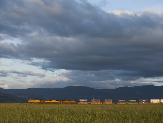 Union Pacific Railroad container train heading north in western Oregon's Willamette Valley under a dynamic spring sky just before sunset on May 7, 2009.