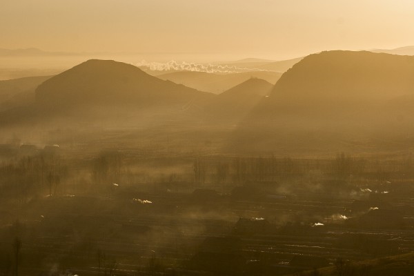 A westbound Jitong Railway freight train approaches Lindong, Inner Mongolia, China, on a hazy November morning in 2005.