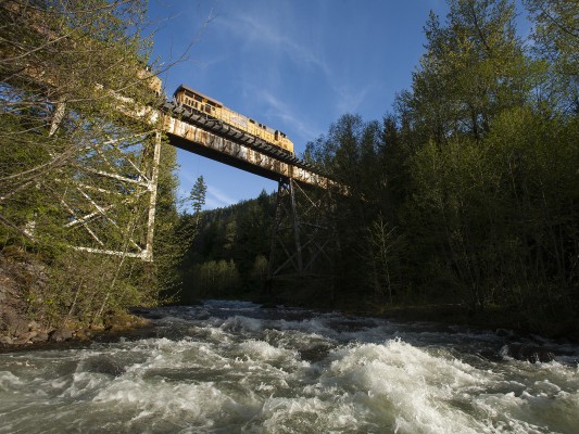 Salt Creek rages with spring rain as a southbound Union Pacific freight train crosses overhead on its climb to Cascade Summit on May 16, 2009.