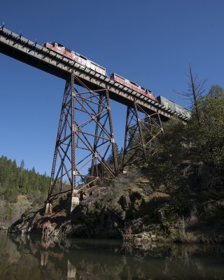 Central Oregon and Pacific Railroad freight train north crossing Grave Creek on a high steel viaduct on February 18, 2010.