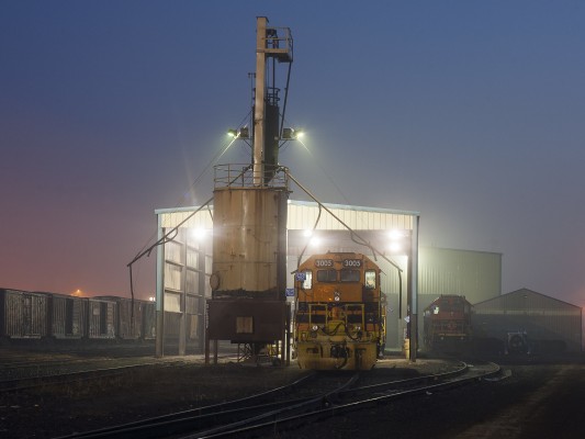 The morning of November 5, 2009, is just beginning to break over Portland and Western's Albany shops as GP40 locomotive 3005 rests under the sanding tower.