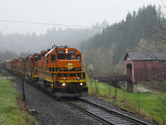 Following a crew change in front of the Chitwood covered bridge, Portland and Western's Toledo Hauler continues its eastward trek on March 31, 2011.