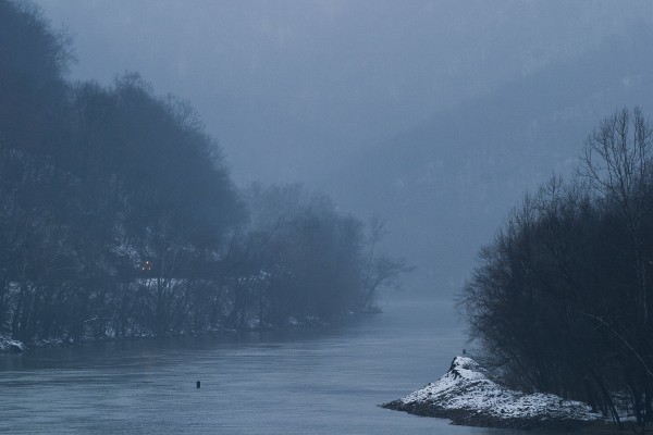 On a dark winter day in 2005, a CSX eastbound coal train rolls along the Kanawha River near Handley, West Virginia.