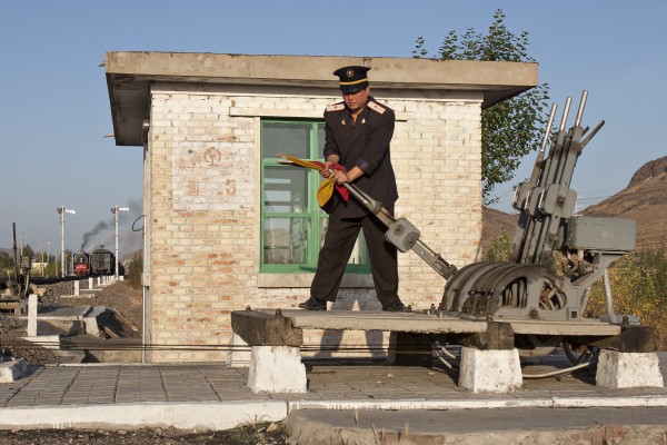 The switchmen at the east end of Yamenmiao siding lines the signals for the Jitong Railway's eastbound local freight train, following a meet with a westbound freight on an October 2005 morning in Inner Mongolia.