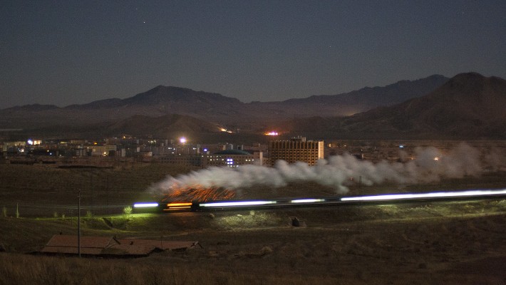 Jitong Railway's eastbound passenger train departs Daban, Inner Mongolia, China, under the light of the moon in the wee hours of a November 2005 morning.