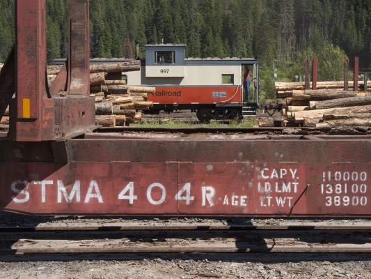 St. Maries River Railroad conductor Pat Hough waives from his caboose as the Clarkia Logger arrives in its namesake town to pickup a trainload of northern Idaho timber in July 2005.