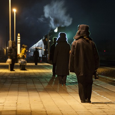 The evening passenger train arrives at the Jitong Railway station in Lindong, Inner Mongolia, China, on a November 2005 evening.