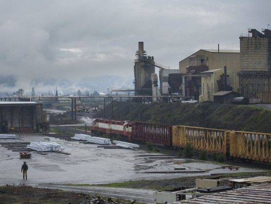 Central Oregon and Pacific Railroad freight train rolling through a lumber mill in Riddle, Oregon, on February 1, 2010.