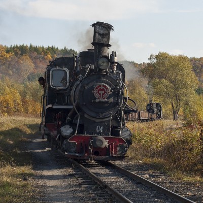 On the afternoon of September 28, 2005, two 0-8-0 C2 locomotives pull and push an eight-car coal train up the grade just west of Lixin.