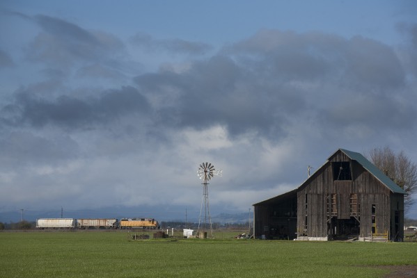 Union Pacific Railroad local freight train heading north with two cars past a windmill near Halsey, Oregon, on February 24, 2010.