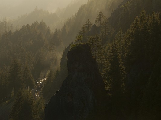 Following closely behind Amtrak on the evening of May 22, 2009, was this Union Pacific freight train, catching some of the day's last sunlight at Rooster Rock in the Oregon Cascades.