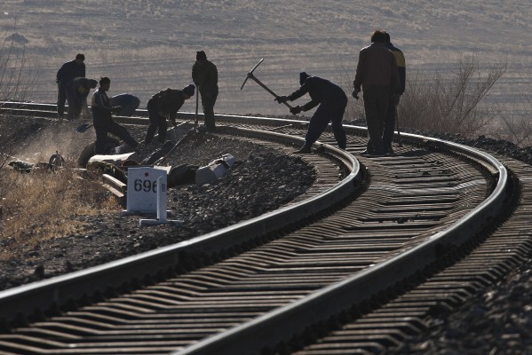 Jitong Railway workers repair the main line just east of Lindong, Inner Mongolia, China, in 2005.