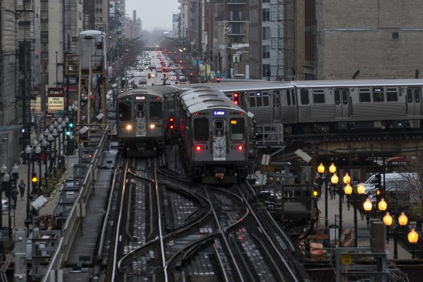 Two Chicago L trains passing at Tower 12 in the southeast corner of the Loop.
