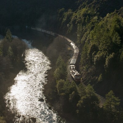 The last rays of daylight shine down into Cow Creek Canyon in southwestern Oregon on February 18, 2010, as a Central Oregon and Pacific Railroad freight train rolls north.