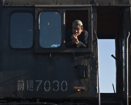 Jitong Railway worker in the cab of QJ no. 70730 at Daban.