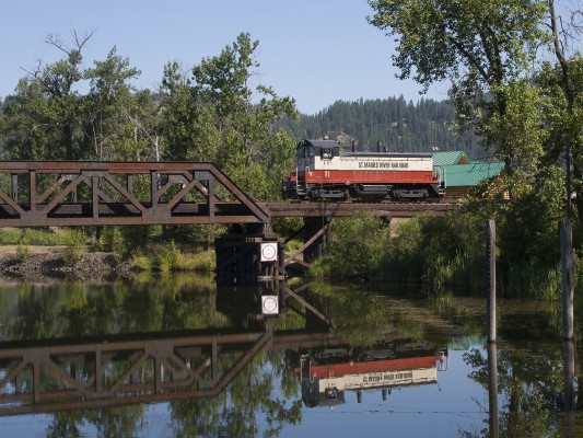 The St. Joe River casts a nearly perfect reflection of a St. Maries River Railroad SW1200 on a warm July morning in St. Maries, Idaho, in 2005.