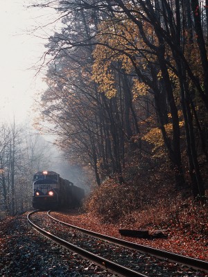 On foggy October morning, a former Conrail SD70MAC leads an eastbound CSX coal train on the Cowen Subdivision near Arcola, West Virginia.