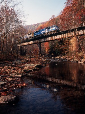 On a bright October morning in 2000, a former Conrail SD70MAC leads an eastbound CSX coal train over Laurel Creek at Centralia, West Virginia.