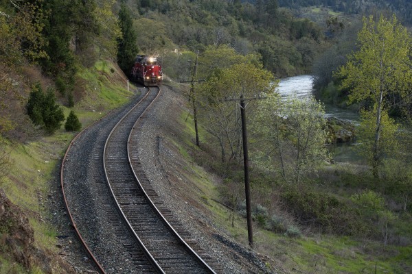 Central Oregon and Pacific Railroad freight train rolling north along the South Umpqua River just north of Myrtle Creek, Oregon, late in the day of April 8, 2010.