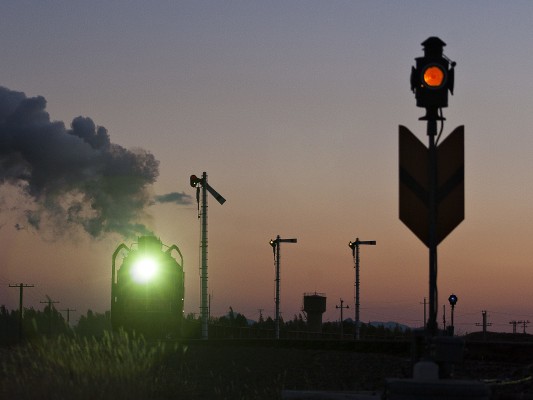 Jitong Railway eastbound freight train departing Gulumanhan, Inner Mongolia, China, at twilight in October 2005.