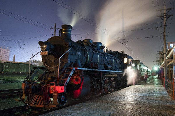SY locomotive and passenger train wait to depart Hegang on the night of September 30, 2005.