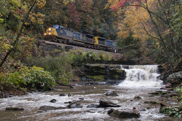 CSX loaded coal train passing a waterfall on Dunloup Creek near Thurmond, West Virginia.